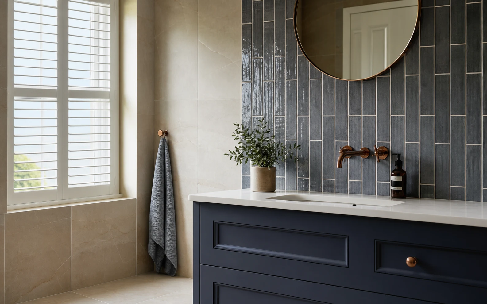 Bathroom with warm stone and deep blue wall tiling